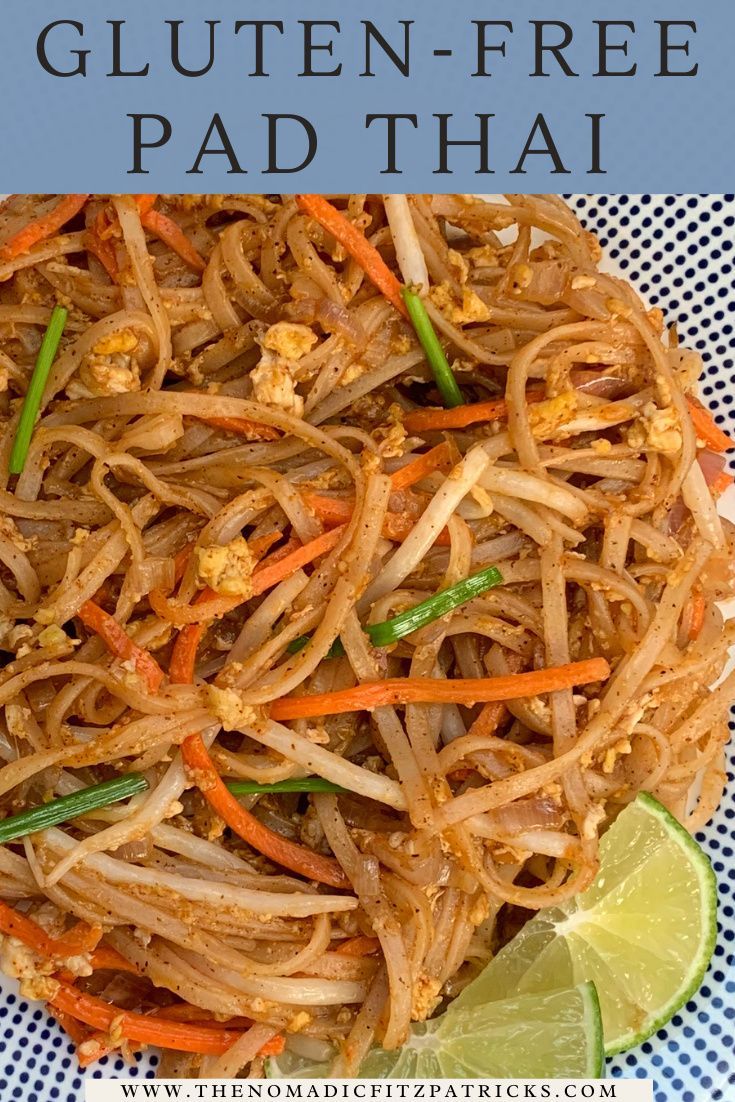 a plate full of pad thai noodles with carrots, onions and green peppers on top