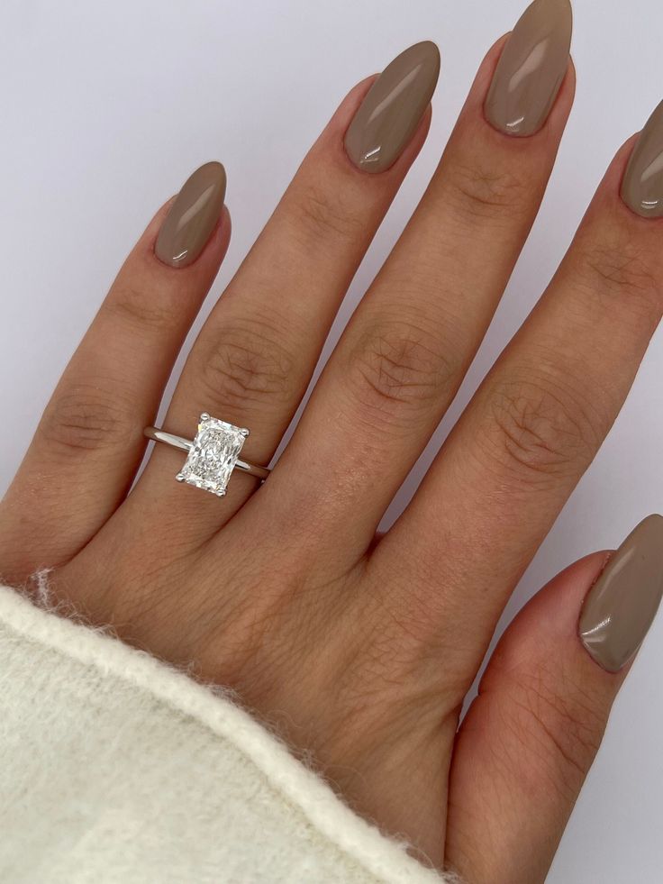 a woman's hand with a diamond ring on it