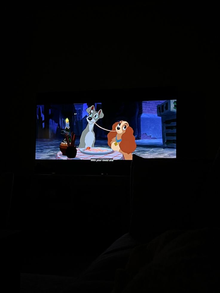 an animated scene on a television screen in the dark