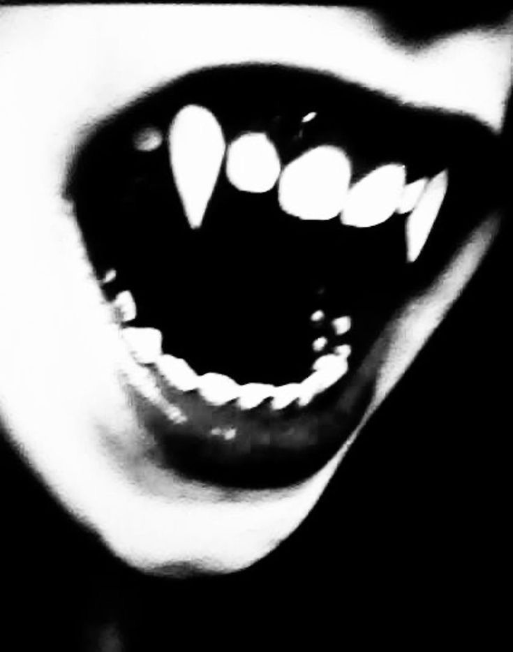 an open mouth with white teeth in black and white