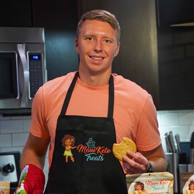 a man in an apron is holding some food