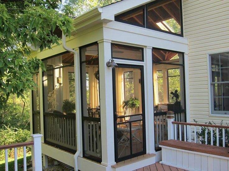 a screened in porch on the side of a house