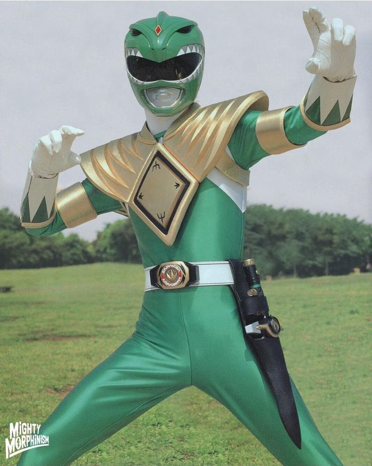 a man in a green and gold power ranger costume posing for the camera with his arms outstretched