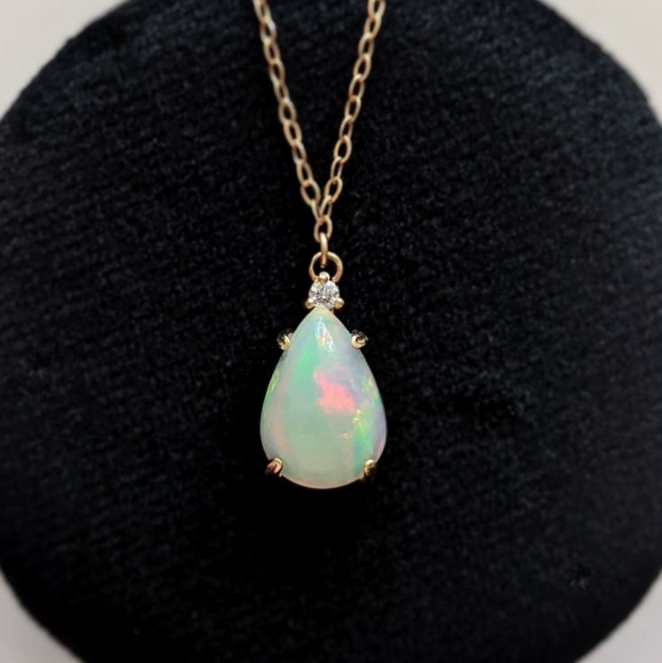 No stone is more mythical or enchanting than the opal. This necklace is a great way to get a clean and modern look while honoring a beautiful stone and style. We showcase this unique and captivating stone in a handcrafted setting, topped with a sparkling diamond. Available in 14k yellow gold Features a natural 13mm x 9mm opal, approx. 2.50ct Accented by a 2mm natural diamond Pendant measures approx. 16mm x 9mm Hanging from a new 18" 14k chain with secure lobster clasp Yellow Gold Opal Teardrop Pendant Jewelry, Opal Drop Gemstone Jewelry, Pear-shaped Opal Jewelry For Formal Occasions, Formal Opal Pear-shaped Jewelry, Pear-shaped Opal Gemstone Necklace, Formal Pear-shaped Opal Jewelry, White Pear-shaped Opal Jewelry, Pear-shaped Opal Gemstone Jewelry, Elegant Pear-shaped Opal Jewelry