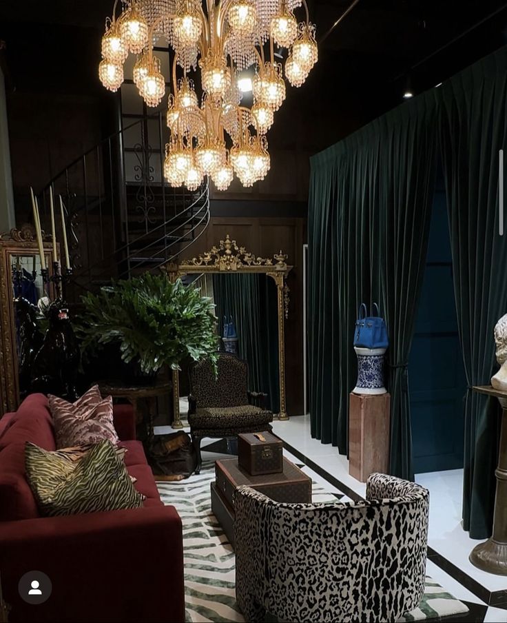 a living room filled with lots of furniture and a chandelier hanging from the ceiling