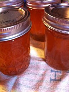 several jars filled with liquid sitting on top of a table