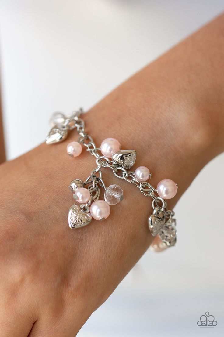 A charming collection of pink pearls, glassy crystal-like beads, and ornate silver heart charms dangle from the wrist, creating a flirtatious fringe. Features an adjustable clasp closure.

Sold as one individual bracelet.

Get The Complete Look! 
Necklace: "Vintage Heartthrob - Pink" (Sold Separately) Squirrel Jewelry, Pink Charm Bracelet, Valentines Bracelets, Pink Charm, Pink Pearls, Pink Necklace, Paparazzi Accessories, Pink Bracelet, Necklace Vintage