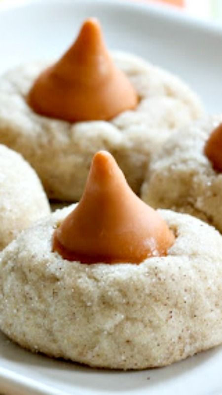 three cookies with peanut butter on top are sitting on a plate