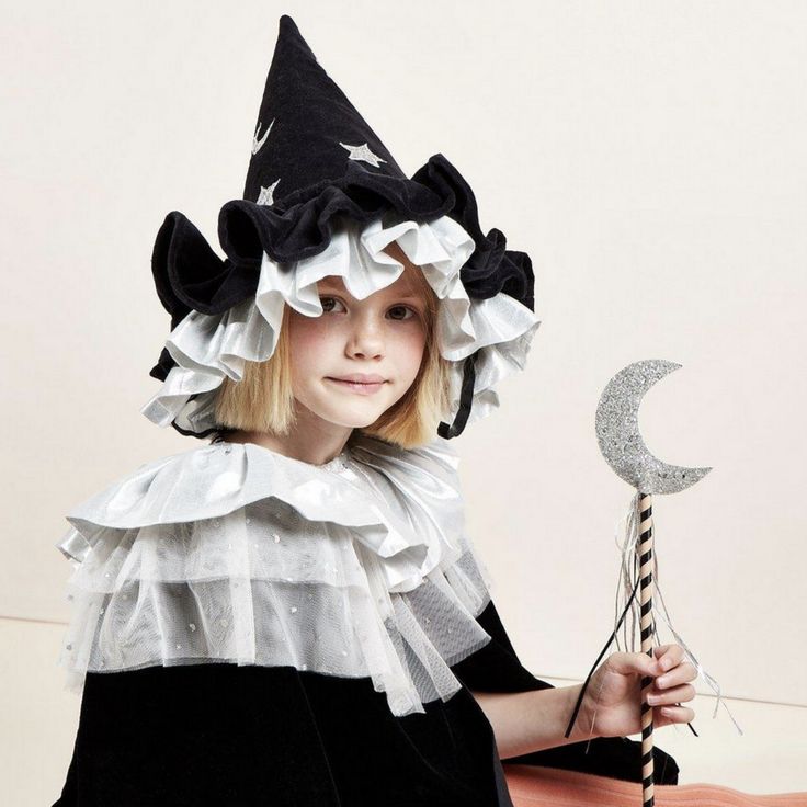 This witch's hat, with ruffle details, is very stylish indeed. It is crafted from black velvet, with silver lamé and silver glitter stars and moons. An essential accessory for Halloween, or to add to a dressing up box for imaginative play any time of the year. The hat is made from soft black velvet It has ruffle details on the brim made from black velvet and shiny silver lamé Silver glitter stars and moons add a delightful embellishment It has a fabric lining to give shape and support The black Childrens Halloween Costumes, Pierrot Clown, Creepy Costumes, Black Witch Hat, Stars And Moons, Authentic Models, Meri Meri, Witch Costume, Glitter Stars