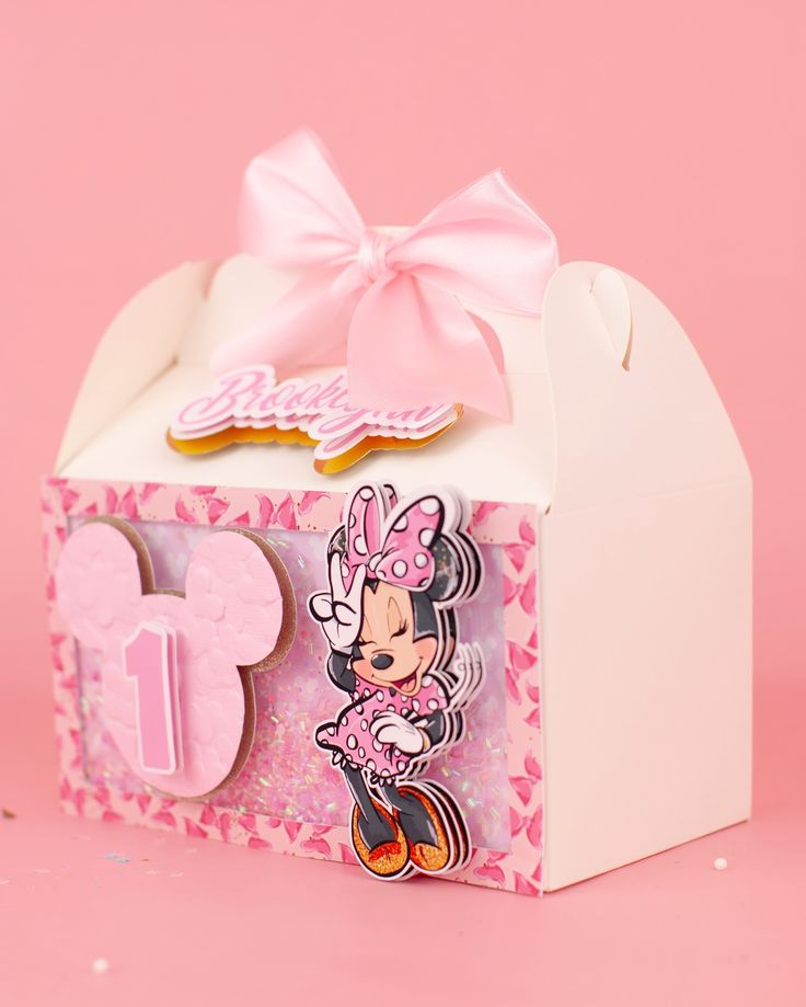 a pink minnie mouse cookie box on a pink background