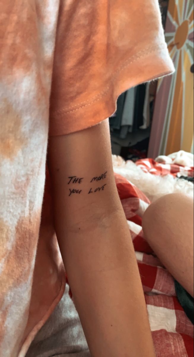 a person with a tattoo on their arm that says, the most you love me