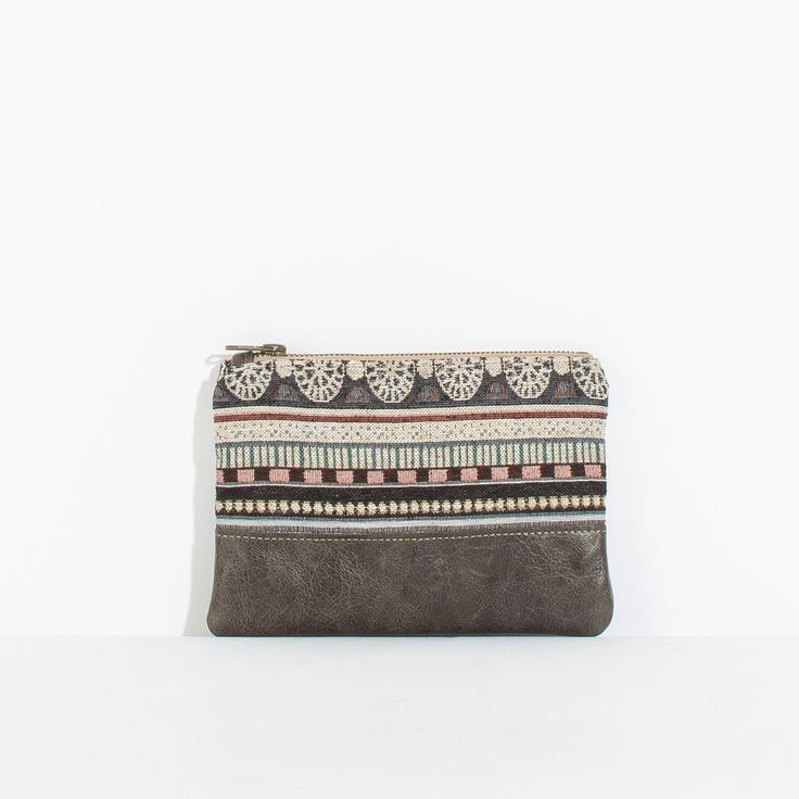 This mini pouch is perfect for holding your basic necessities. A fun alternative to your typical wallet. You can carry it on its own if you're traveling light or it fits great inside one of our totes. *Please note that all of our bags are made from small batches of sourced fabric. Therefore each bag is unique and may be slightly different from the one pictured. Beige Zipper Pouch For On-the-go, Trendy Brown Zipper Pouch, Casual Pouch Clutch For On-the-go, Beige Travel Wallet With Zipper Pouch, Beige Travel Coin Purse Pouch, Beige Pouch Coin Purse For Everyday Use, Travel Beige Pouch Coin Purse, Beige Zipper Coin Purse For Everyday Use, Everyday Coin Purse With Cell Phone Pocket