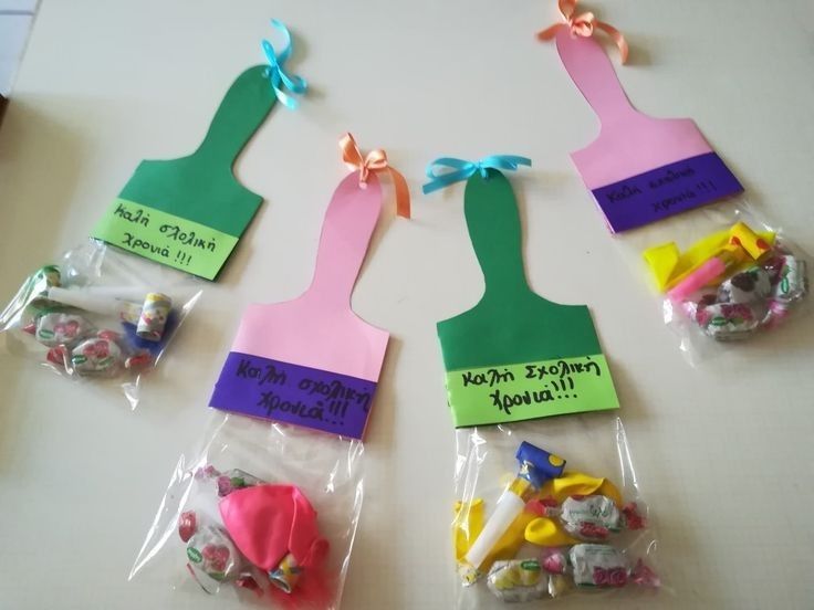 several pieces of crafting material in plastic bags with name tags attached to the handles