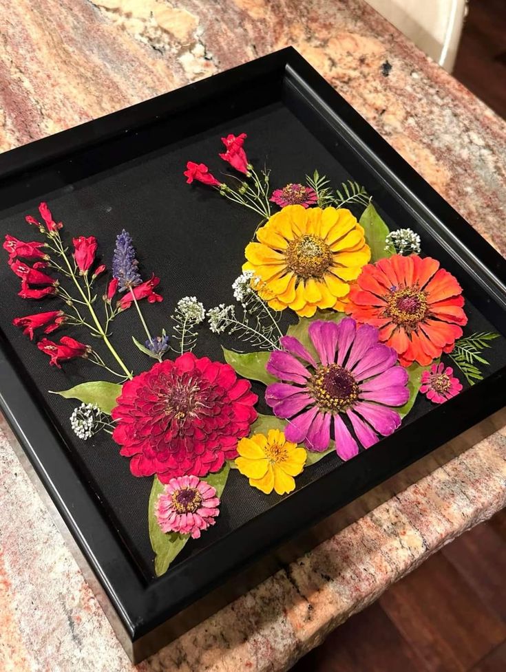 a black tray with flowers painted on it