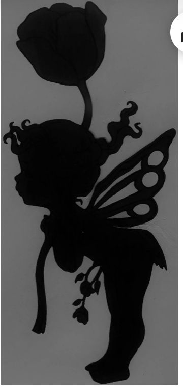 a silhouette of a fairy holding a flower