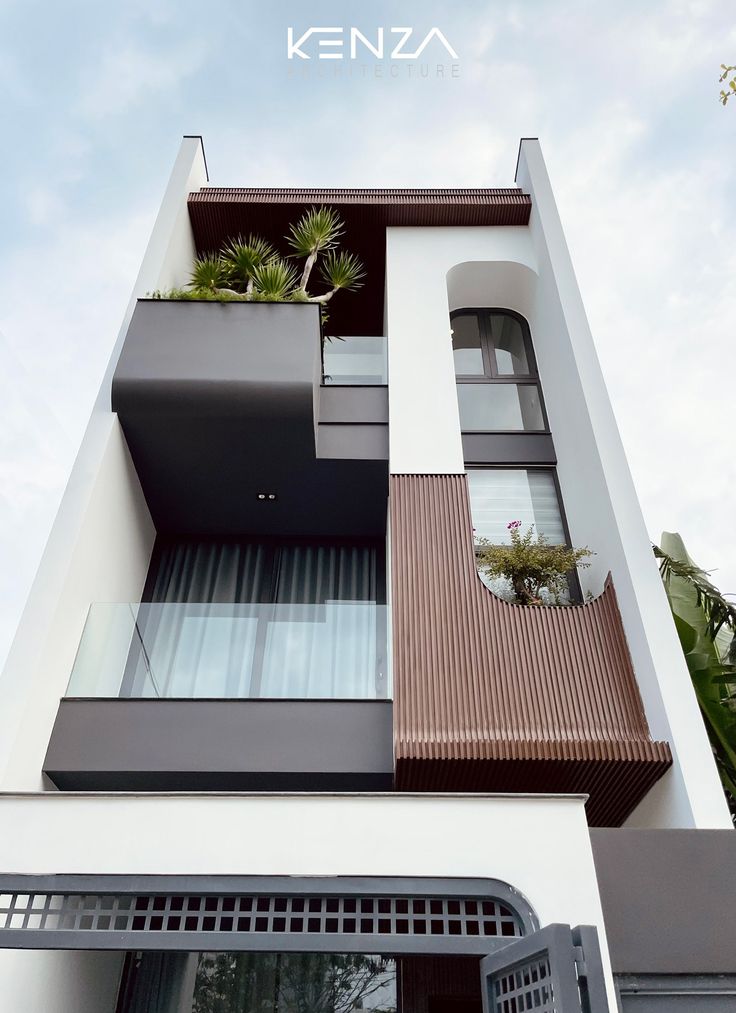 an apartment building with plants on the balconies