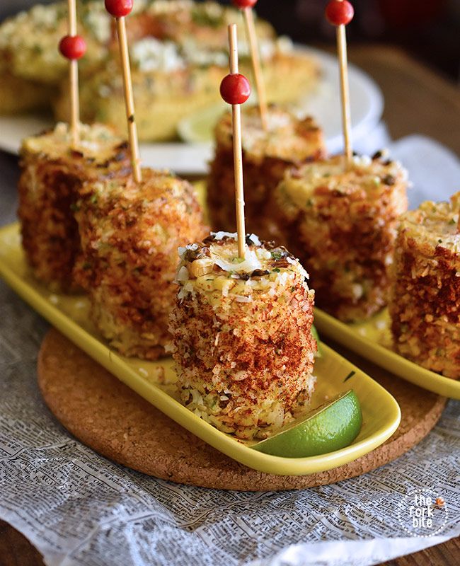 several appetizers with toothpicks on them are sitting on a yellow plate