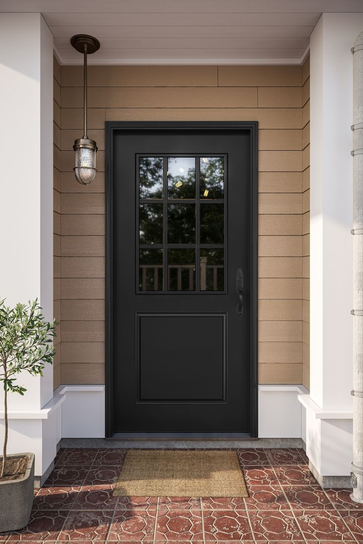 a black front door with two sidelights and a potted plant