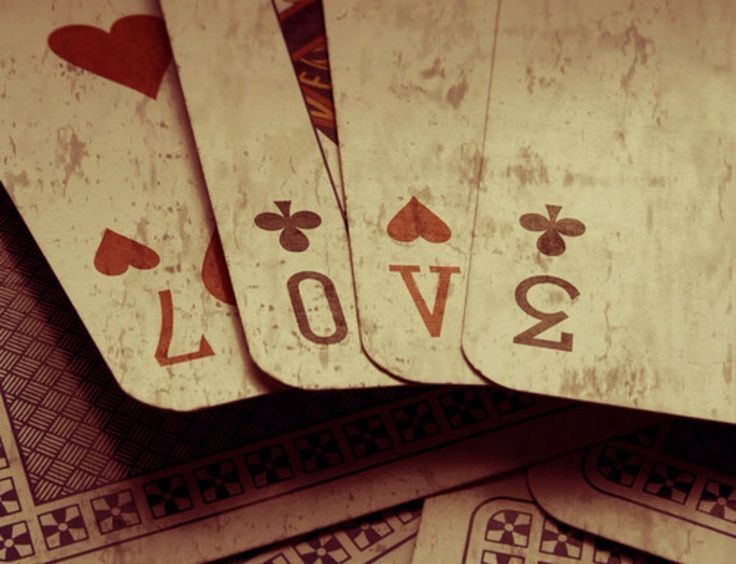 several playing cards are stacked on top of each other with the word love spelled in them