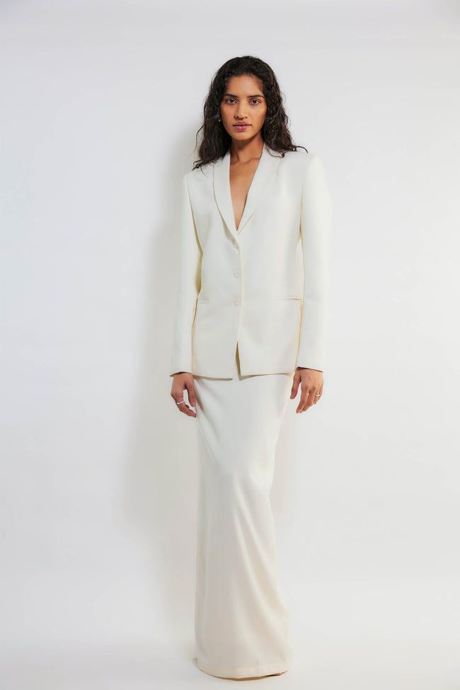 Deme By Gabriella | Lena White Blazer And Skirt Set | INDIASPOPUP.COM Classic Evening Skirt Suit With Notch Lapel, Elegant Cream Suits For Spring, Bridal Blazer And Skirt, Chic White Skirt Suit For Spring, White Structured Blazer For Formal Occasions, Elegant Off White Blazer For Work, Elegant Off White Formal Blazer, Elegant Cream Skirt Suit For Formal Occasions, Sleek White Blazer For Semi-formal Occasions