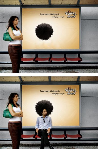 there is a man sitting on a bench in front of a wall with an afro