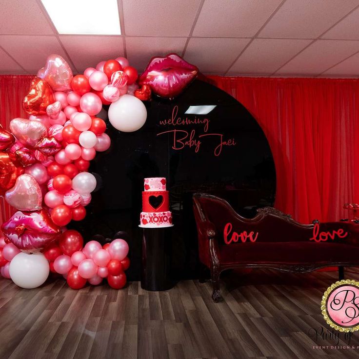 the balloon arch is decorated with red, white and pink balloons for valentine's day