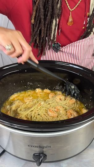 a woman stirring up some food in a slow cooker