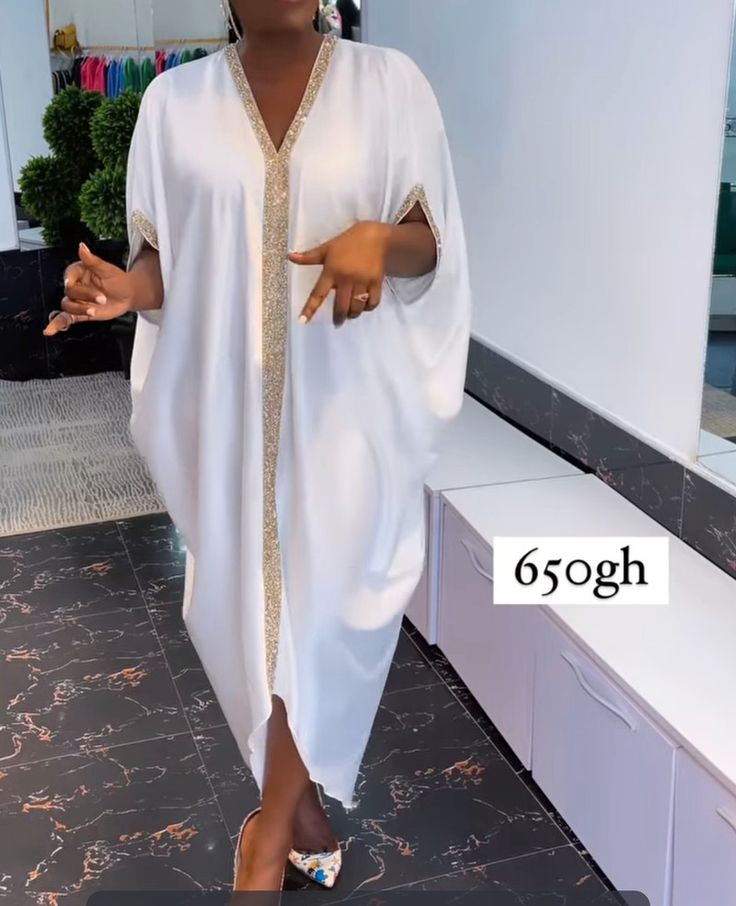 White silk kimono boubou dress with gold trimming design in front White Bubu Gown Styles, White Bubu Gown Styles Silk, White Bubu Gown, Bubu Gown Styles Silk, White Kimono Dress, Owambe Styles, Boubou Dress, Silk Kaftan Dress, Bubu Gown Styles