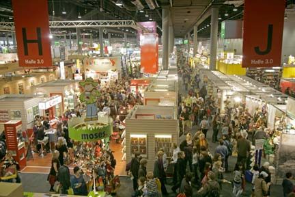 an indoor market with lots of people walking around