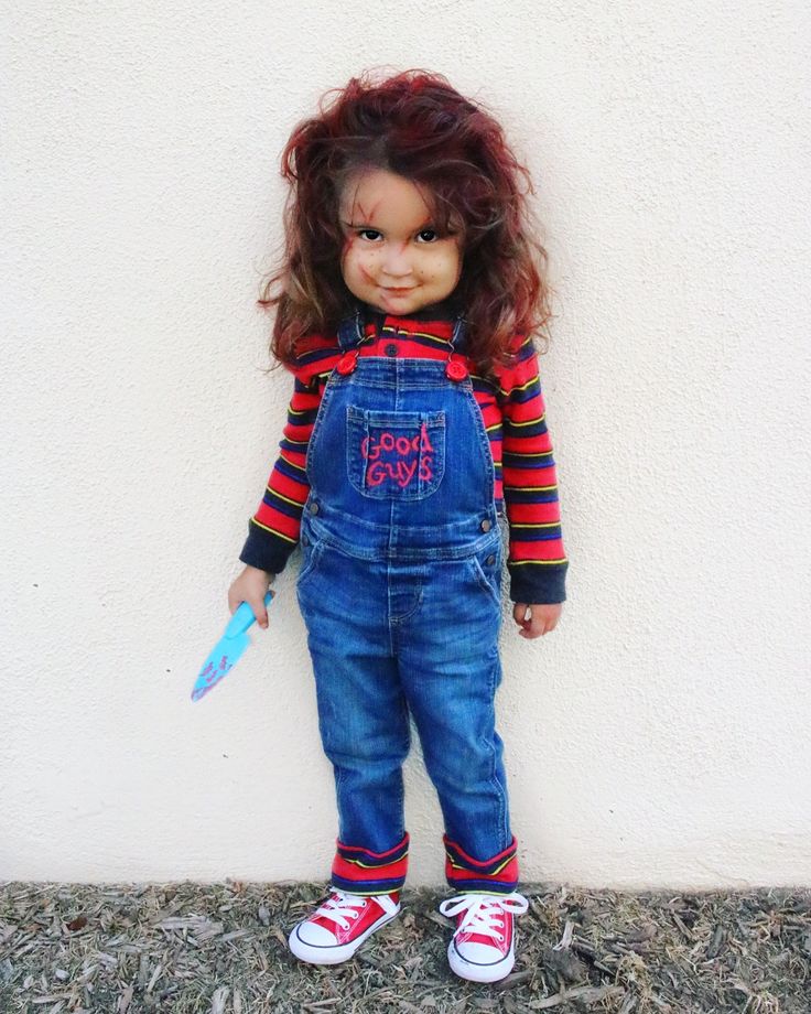 a doll with red hair wearing overalls and holding a toothbrush in her hand