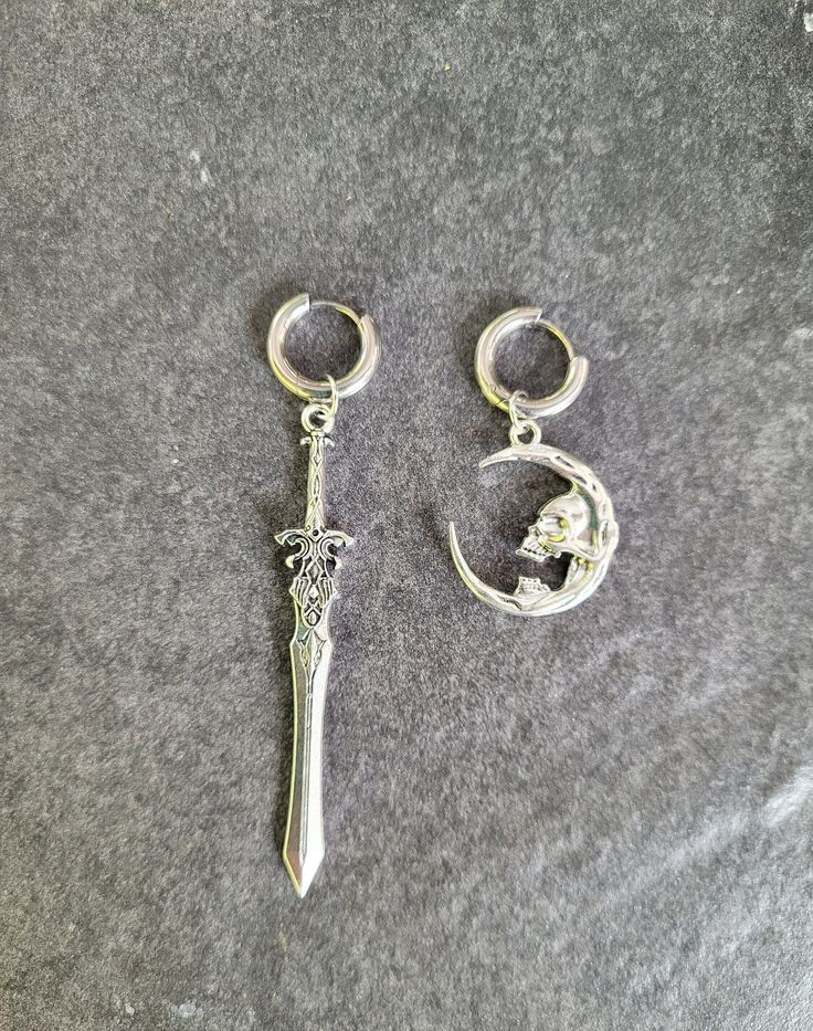 316L Surgical Steel, Hypoallergenic **Choose single earrings or pairs...mix and match options** Great for guys or girls!  Mix and match. Charms are removeable. Sword measures about 3" long. Lightweight and comfortable. Fit normal pierced ears. Click below to see more goth earrings: www.etsy.com/shop/TikiTorchDesigns?ref=seller-platform-mcnav&search_query=goth+earrings **Great gift for yourself or a friend!  Choose the gift message option when you check out if you want me to include a FREE gift b Gothic Pierced Jewelry For Streetwear, Gothic Metal Earrings For Streetwear, Gothic Silver Earrings For Streetwear, Pierced Men, Men Grunge, October Jewelry, Skull Moon, Grunge Earrings, Hoop Jewelry