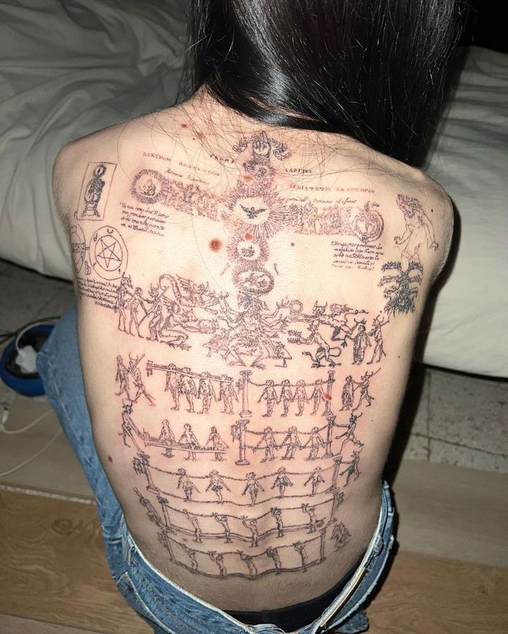 the back of a woman's body with drawings on it