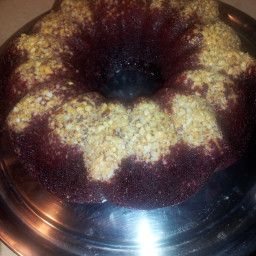 a bundt cake sitting on top of a metal pan covered in crumbs