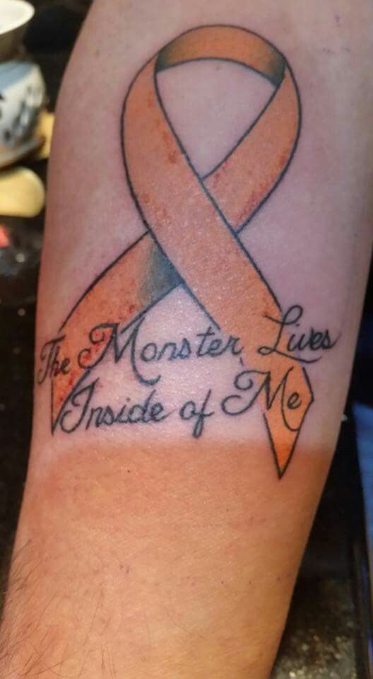 a man with a tattoo on his arm that says, the monster lives inside of me