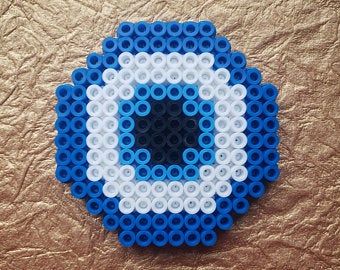 a blue and white object made out of legos on top of a brown surface