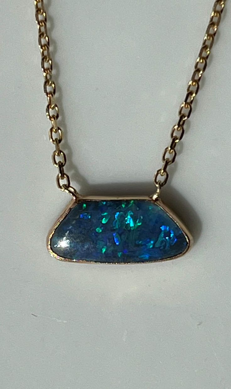 "At the center of this gorgeous necklace is an irregular shape opal14K encased in 14K gold and set onto a 14K gold chain. The free form opal stone is about 13mm at its widest and is about 4mm long. The chain is 16\" long. The lobster claw closure is marked 14K. This lovely piece is in beautiful estate condition. Please see all photos for details and condition. Thank you for looking!" Fine Jewelry Opal Cabochon Necklace, Unique Oval Opal Necklaces, Unique Opal Necklaces For Formal Occasions, Oval Opal Necklace With Polished Finish, Unique Yellow Gold Opal Necklaces, Unique Yellow Gold Opal Necklace, Cable Jewelry, Boulder Opal Necklace, Gold Link Bracelet