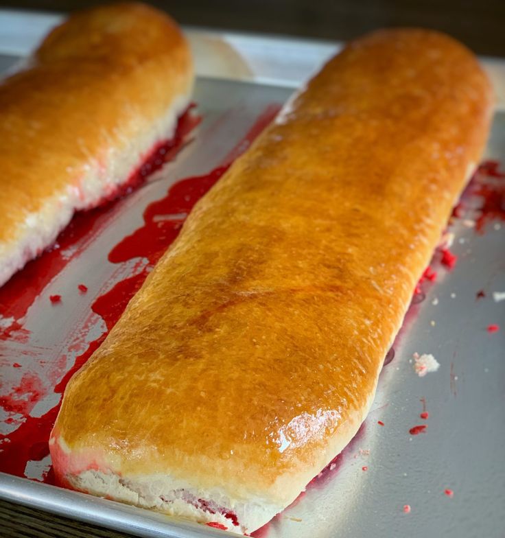 two long loafs of bread sitting on top of a pan