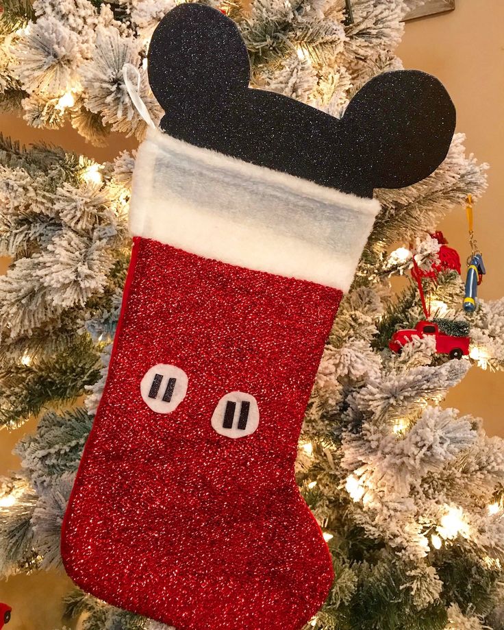 a mickey mouse stocking hanging from a christmas tree