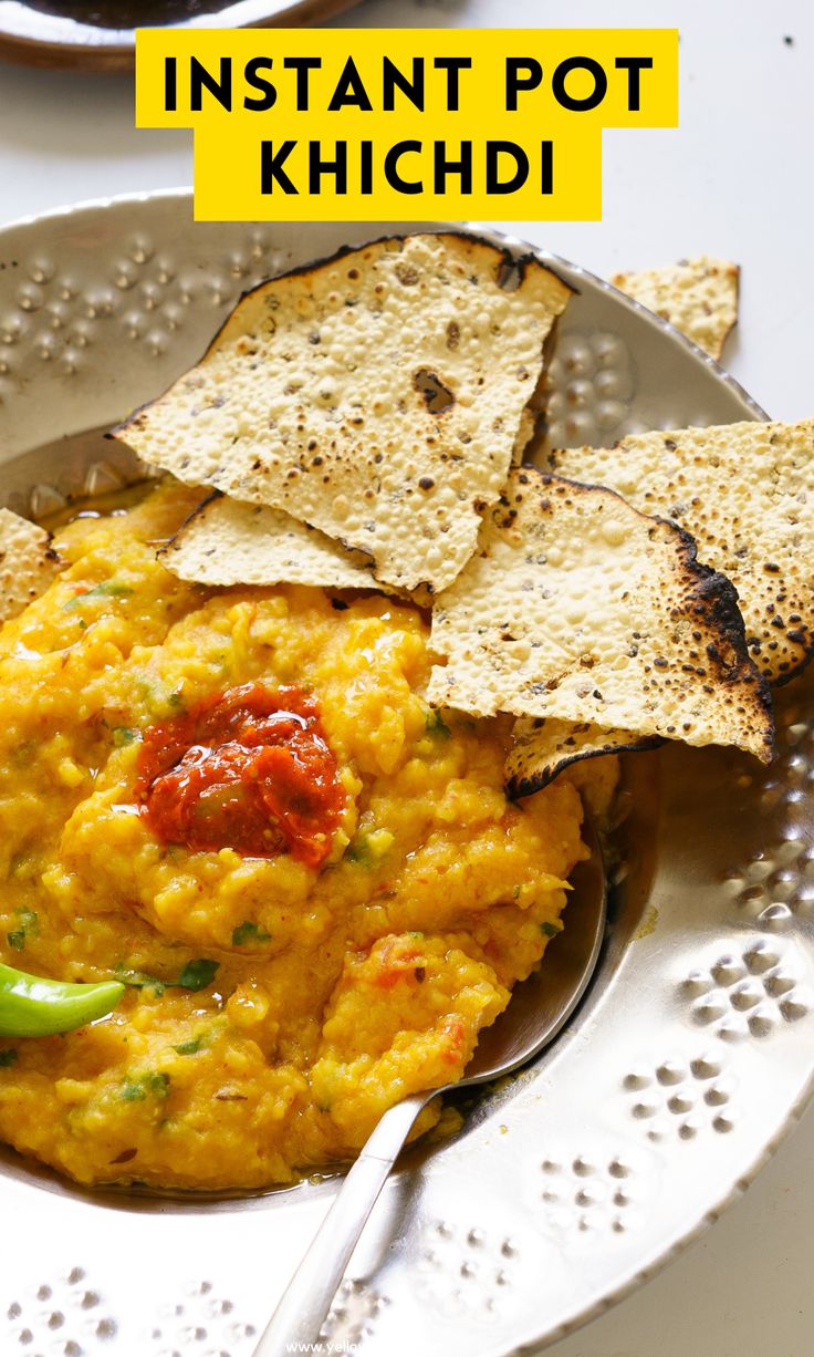 a white plate topped with guacamole and tortilla chips next to a bowl of salsa