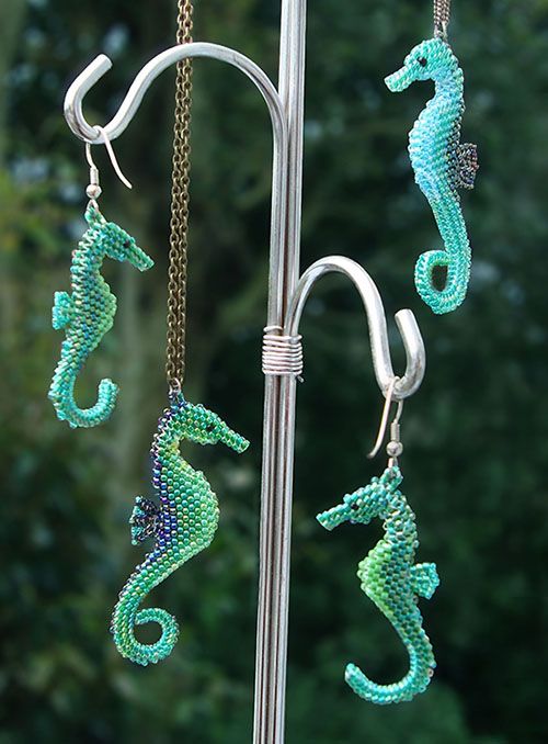 three seahorses are hanging from a pole