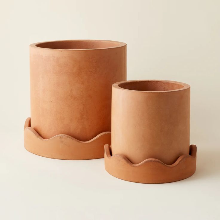 two large clay pots sitting next to each other