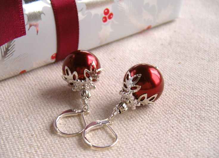 Get merry with these best-selling, stunning Red Christmas Ball Earrings! Perfect to match a festive holiday look or glam up a little black dress. Or wear them every day! Silver plated bead caps with floral motifs accent shiny red glass pearls that are 14mm in diameter. Ear wires shown in photos are silver-plated lever-back-style ear wires. Choose in the options whether you would like silver-plated or sterling silver ear wires. There is also an option for sterling silver french hook ear wires (no Christmas Jewelry Diy, Ornament Earrings, Red Christmas Ornaments, Christmas Necklace, Holiday Earrings, Ball Earrings, Earrings Christmas, Holiday Earring, Christmas Ball