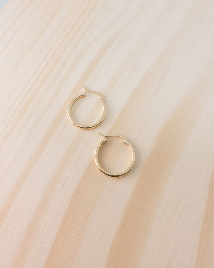 details: minimal hoops in solid 18k yellow gold finish choice of 15mm or 20mm diameter in size band width approx. 1.5mm latch back closure Style with Northern star pendent, solo freshwater pearl pendent or mini lock and key pendent Tarnish Resistant Small Hoop Jewelry For Everyday, Tarnish-resistant Small Hoop Everyday Jewelry, Everyday Small Hoop 14k Gold Jewelry, Timeless Hoop Jewelry For Everyday, Everyday 14k Gold Small Hoop Jewelry, Classic Jewelry With Gold Clasp, Timeless Everyday Hoop Jewelry, Classic Everyday Jewelry With Gold Clasp, Classic 14k Gold Open Circle Jewelry