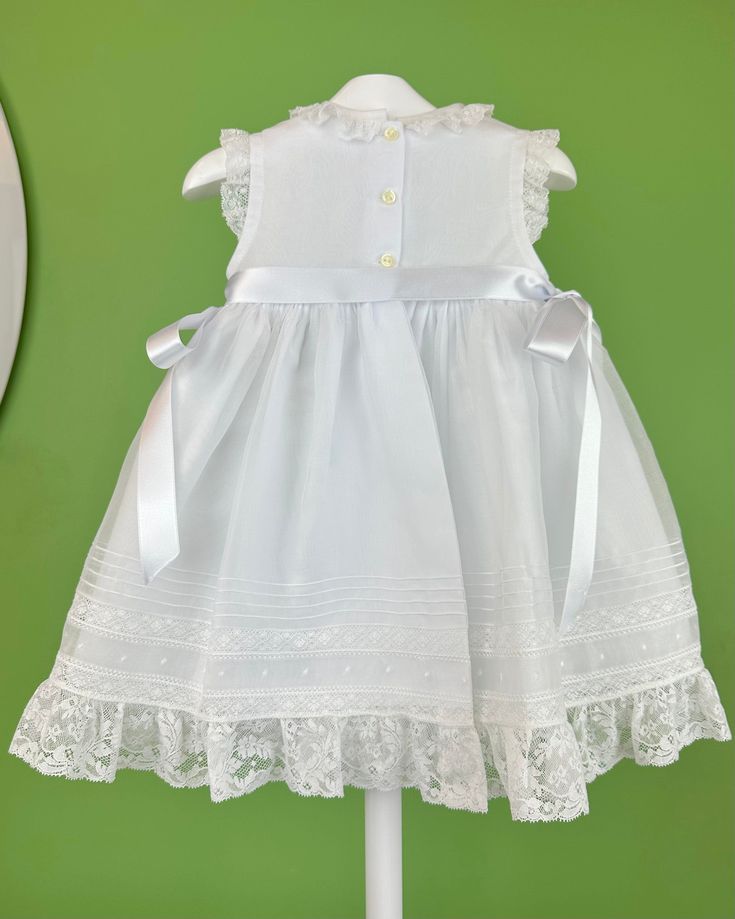 An elegant and delicate white dress for girls to wear on a special day. It is made with swiss organdi and laces. It has buttons on the back for closure. Made in Spain Inside: 65% polyester 35% cotton Dry Clean Final sale, no exchanges nor returns are accepted Girls White Dress, Spanish Fashion, First Communion Dresses, Baptism Dress, Communion Dresses, Christening Gowns, Newborn Outfits, First Communion, Christening