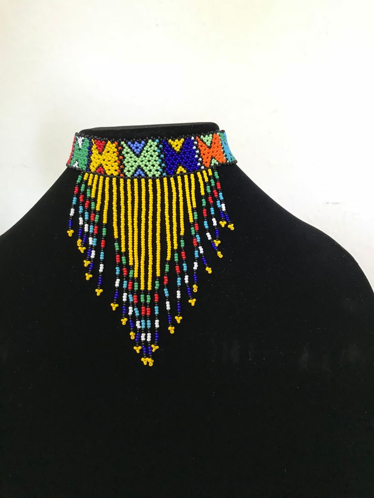 100 % Handmade with fine beads. One size fits most, Beaded Zulu tassel necklace that can also be worn as a head band. The band is multicolored and the tassel has a solid color with a finish of different colors. We have five solid colors for the tassel, Red, Orange, Blue, white and yellow. Made in South Africa, Durban. Adjustable Colorful Beads For Festival, Adjustable Multicolor Beaded Necklaces For Festivals, Adjustable Beaded Choker, Adjustable Tiny Beads Necklace For Festivals, Traditional Multicolor Jewelry With Beaded Fringe, Traditional Multicolor Beaded Fringe Necklaces, Traditional Multicolor Beaded Necklaces With Fringe, Artisan Multicolor Adjustable Beaded Necklaces, Traditional Multicolor Beaded Necklace With Fringe