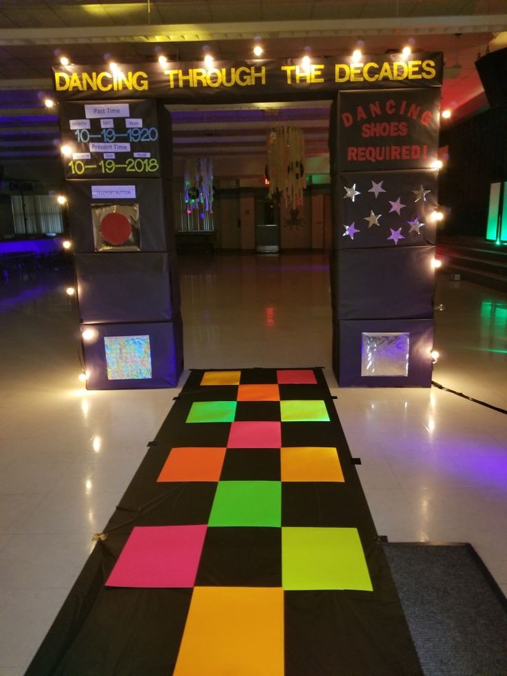 the dance floor is decorated with bright colors and black, yellow, pink, green, orange, and purple squares