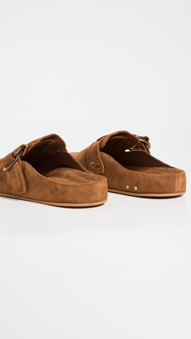 Find BEEK Vulture Clogs on Editorialist. Upper: Cowhide suede. Lining: Leather. Molded footbed. Antiqued hardware. Buckle strap. Round toe. Rubber sole. Imported, Mexico. This item cannot be gift-boxed. Spring Suede Mules With Buckle Closure, Suede Slip-on Mules With Buckle Closure, Spring Brown Clogs With Suede Lining, Suede Slip-on Clogs With Buckle Closure, Brown Suede Mules With Round Toe, Chic Suede Mules With Rubber Sole, Brown Suede Clogs With Cushioned Footbed, Brown Slip-on Mules With Buckle Closure, Brown Suede Closed Toe Mules