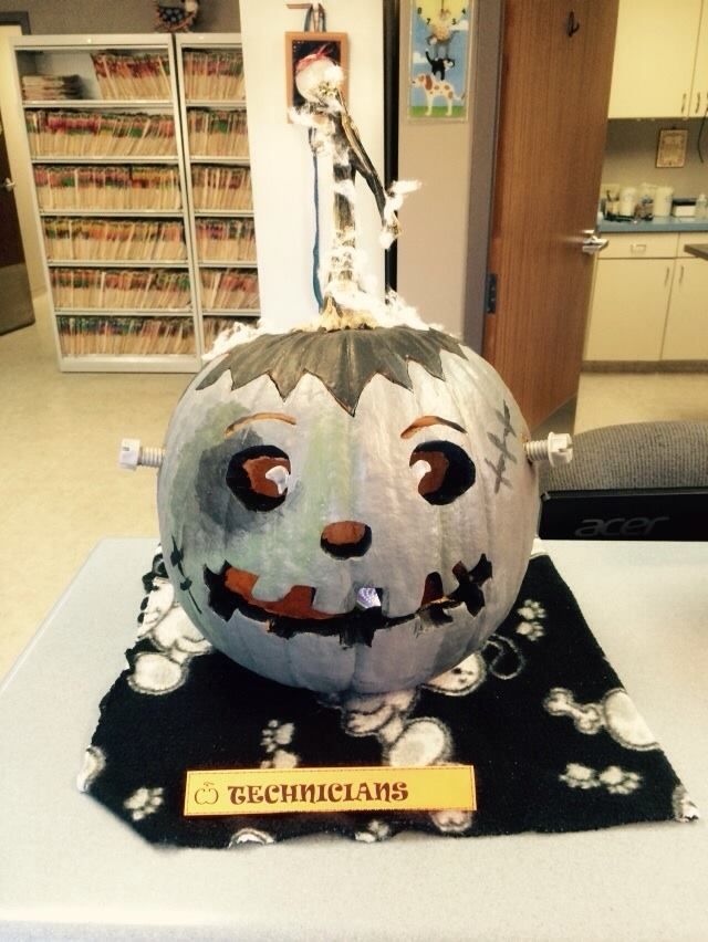 a decorated pumpkin sitting on top of a table