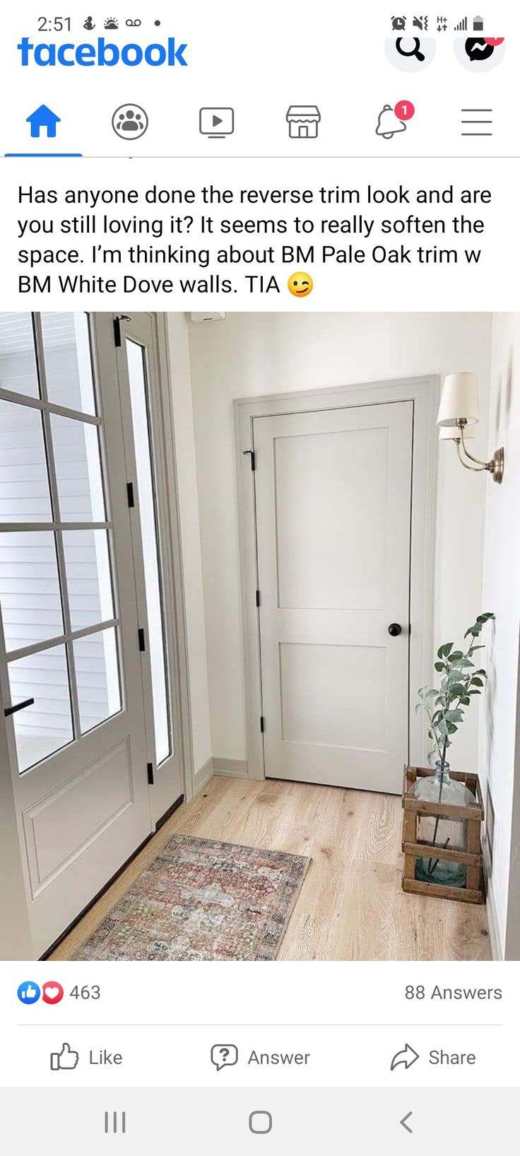 an image of a white door in a room with wood floors and rug on the floor