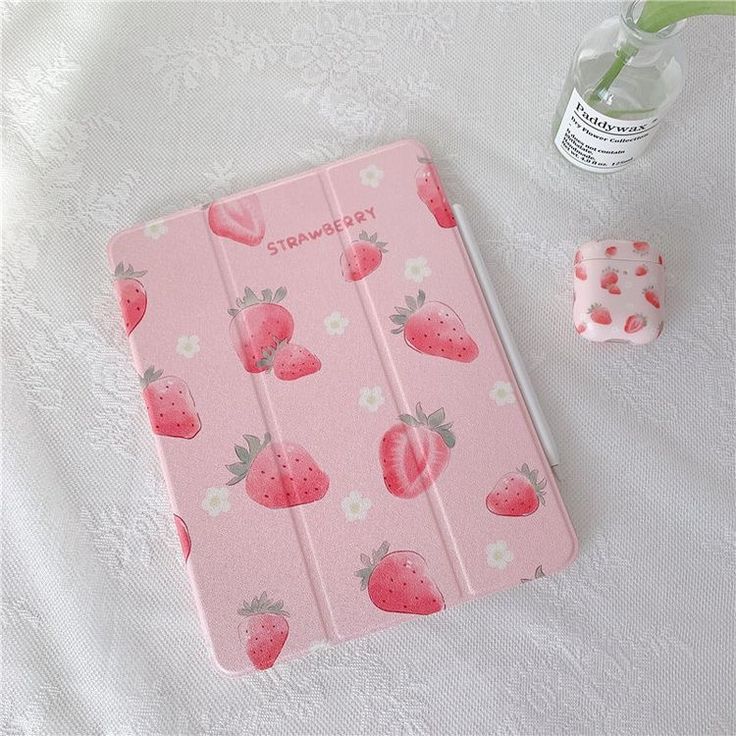 a pink ipad case with strawberries on it